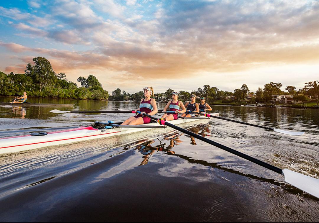 Four female rowers one the Brisbane River