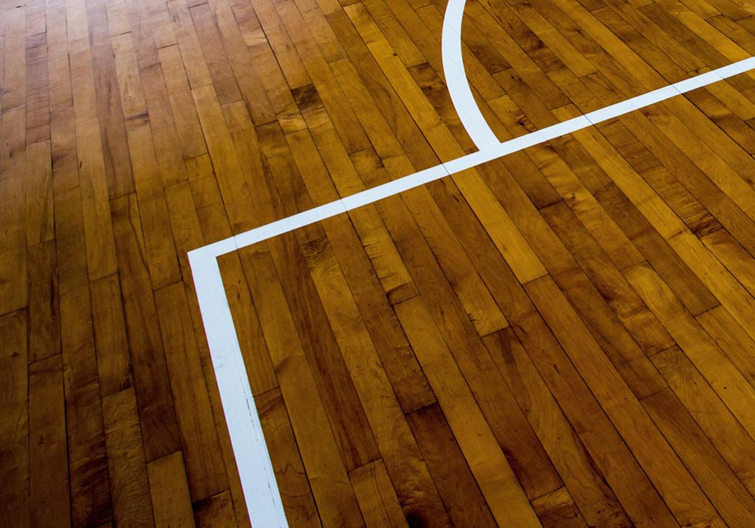 Close-up of line markings on an indoor wooden playing court floor