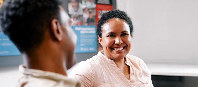 Two people talking at the UQ Poche Centre for Indigenous Health