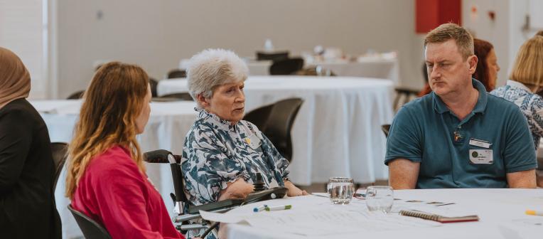 A group of people sitting at a table in discussion