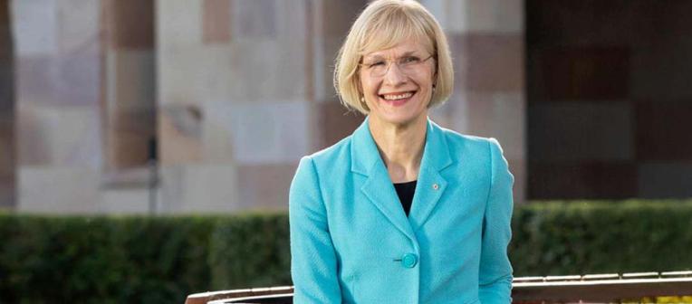Vice-Chancellor Professor Deborah Terry sitting outside UQ St Lucia campus.