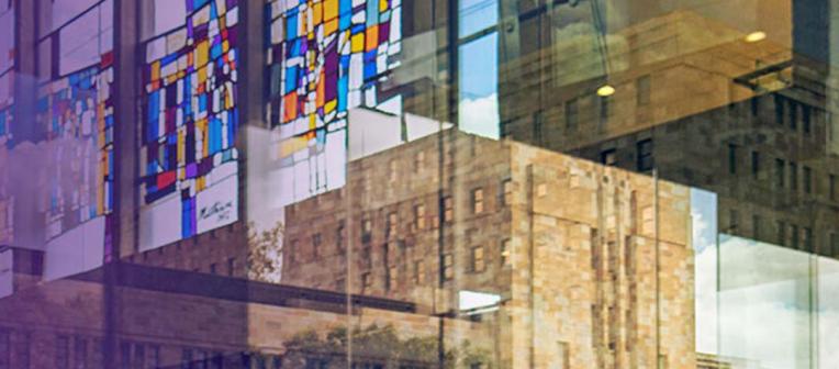 Overlay of art museum stain glass windows and buildings. 
