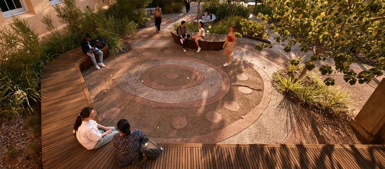 Students sitting in the Reconciliation Garden, Herston