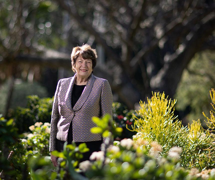 The Honourable Dr Mary Crawford standing in a garden