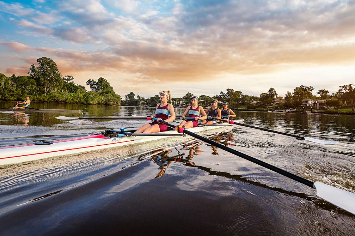 Four female rowers one the Brisbane River