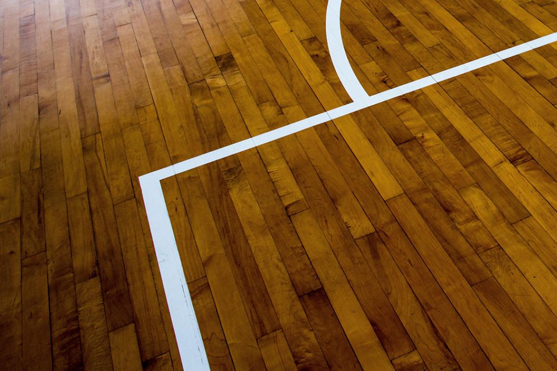 Close-up of line markings on an indoor wooden playing court floor