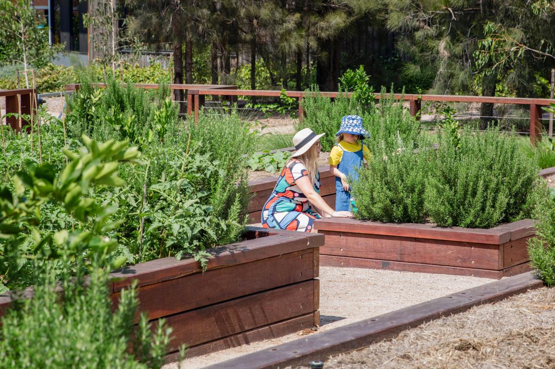 Woman and child in UQ's community garden