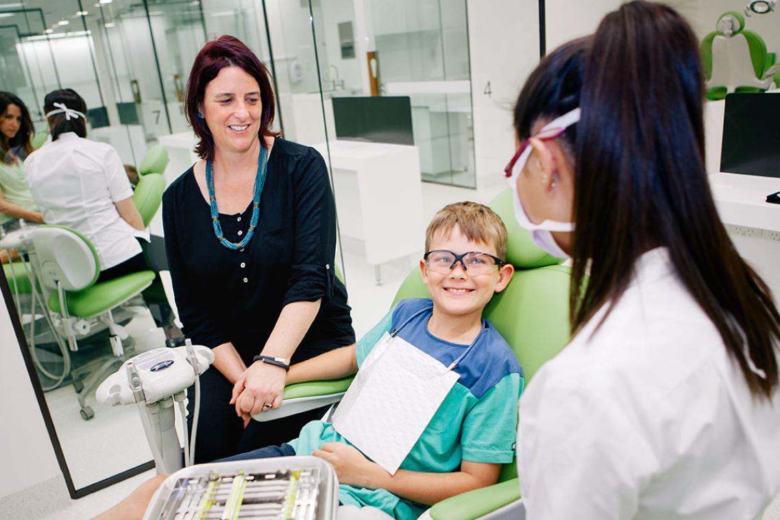 Child sitting in dentist chair.