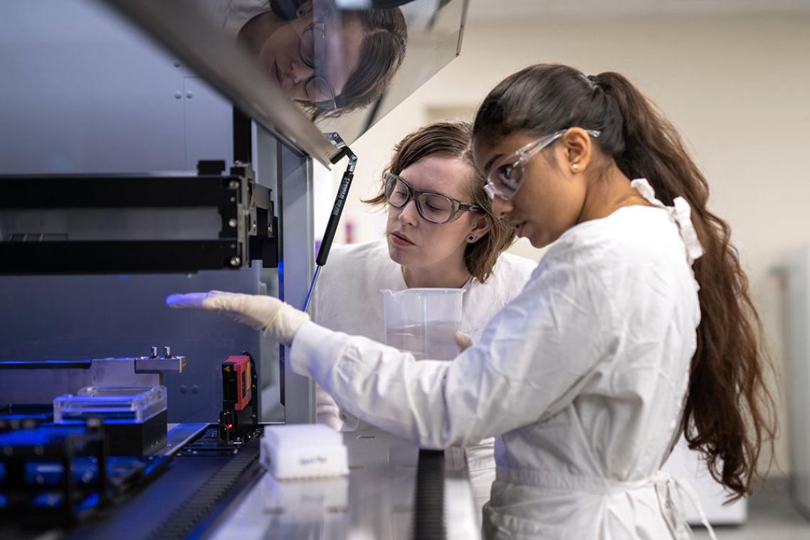 Two students examining an experiment