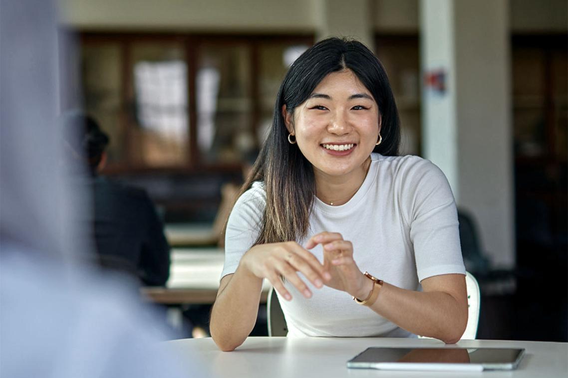 Smiling student talking to anothet student