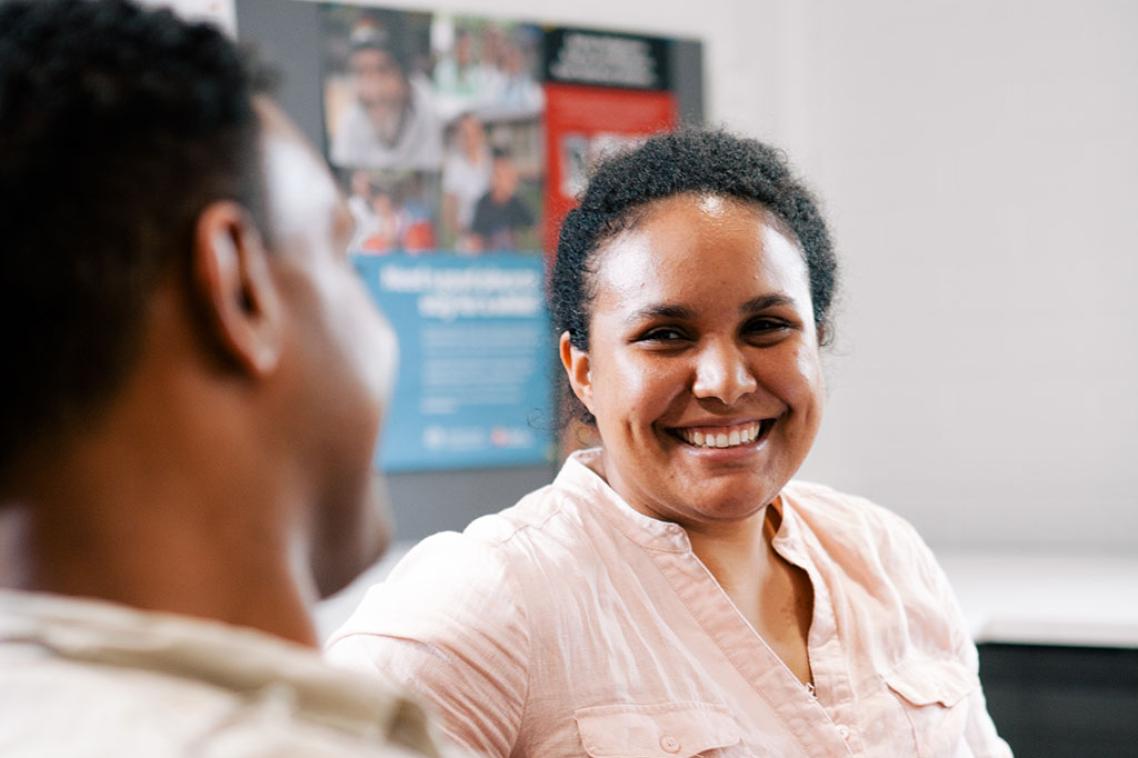 Two people talking at the UQ Poche Centre for Indigenous Health