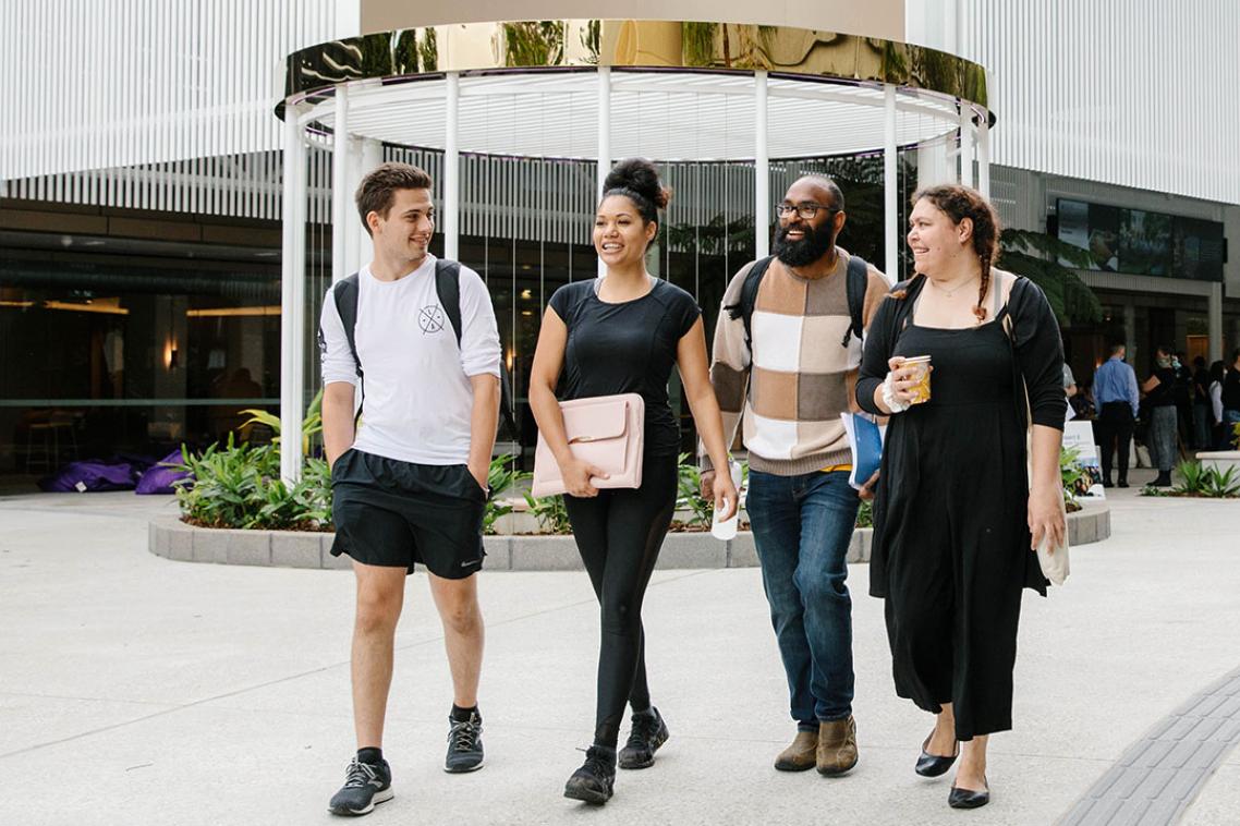 Four indigenous students walking outside Student Central