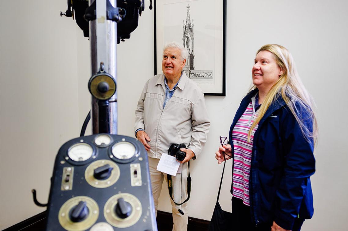 Visitors inspecting an exhibit