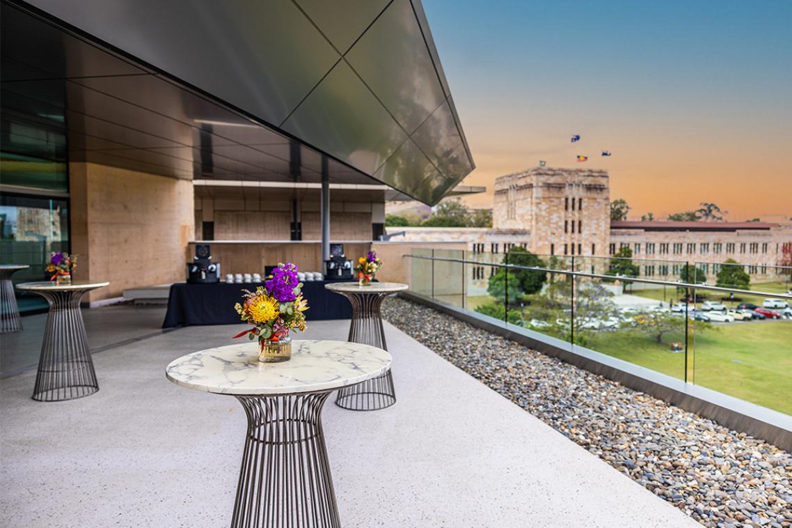 3 cocktail tables with flowers on the balcony of the Terrace Room.