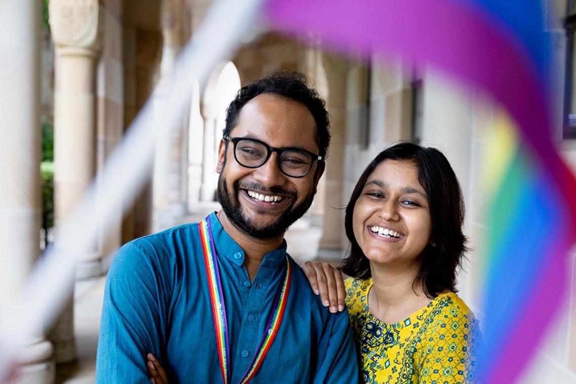 Two staff looking at a Pride flag