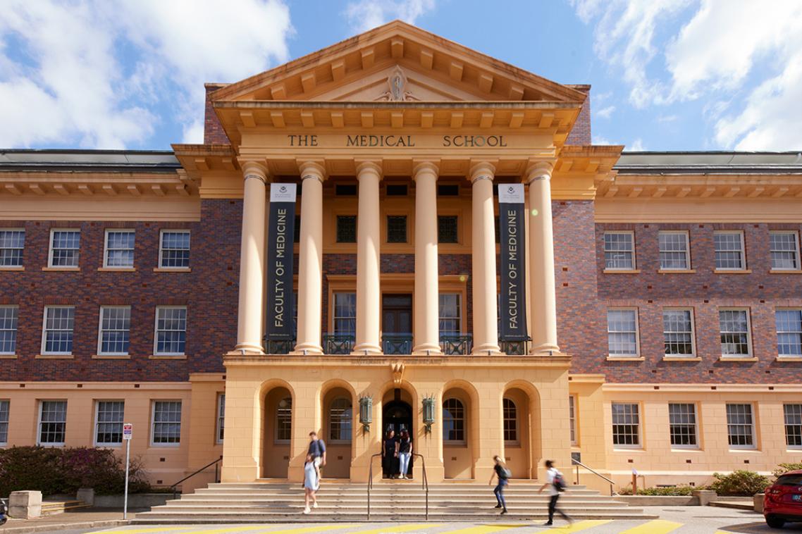 Front view a Palladian style building made of red brick and cream trim. 