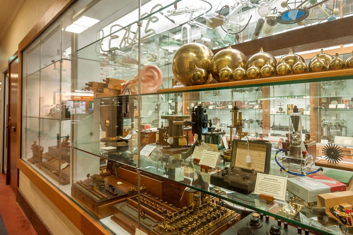 A display of science-related artefacts behind a glass wall.