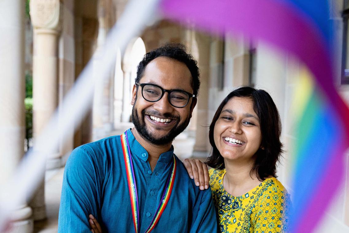 Two staff members wearing Pride lanyards