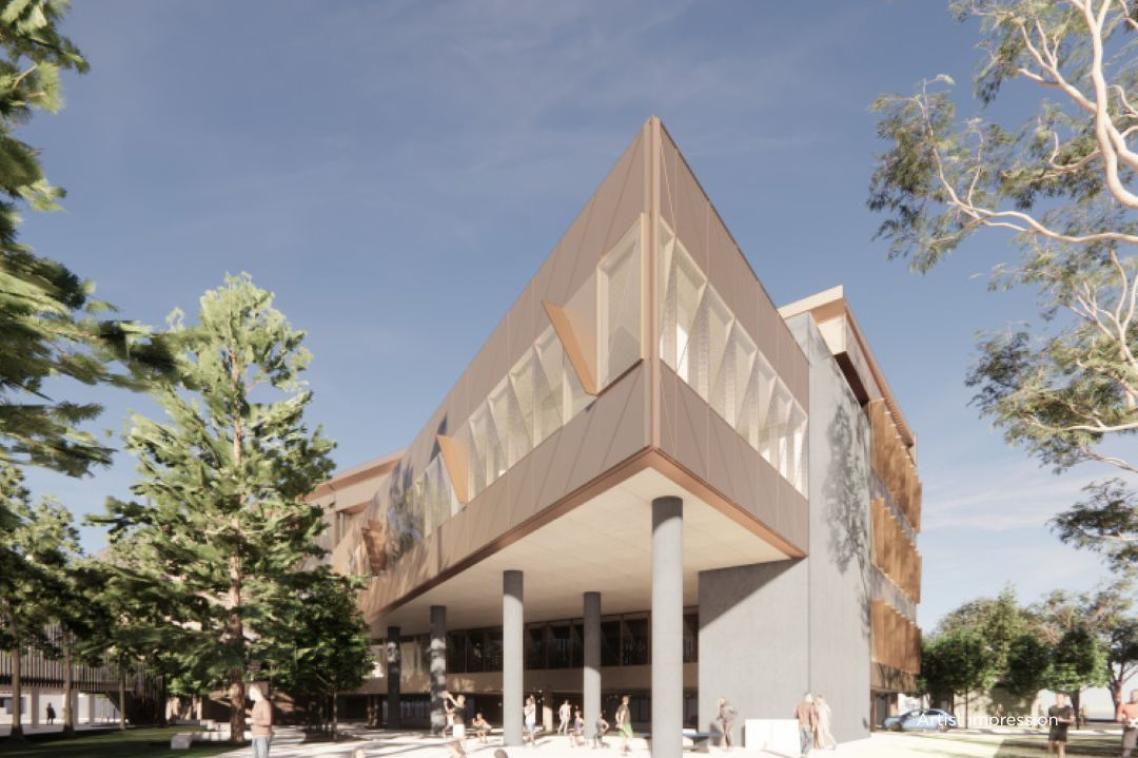 Exterior view of a modern, angular building with high under-croft supported by columns.