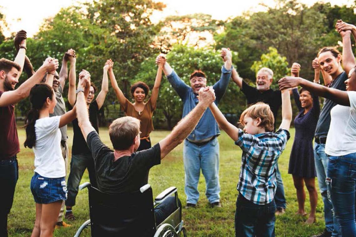 A group of people celebrating in a park